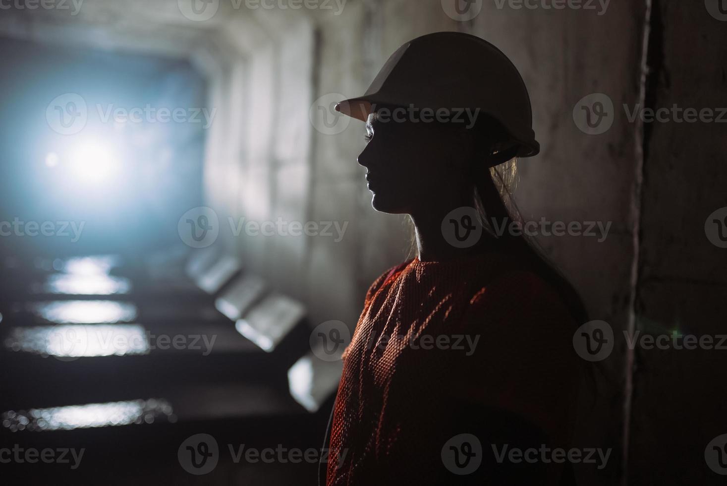 Silhouette of a female digger in the tunnel photo