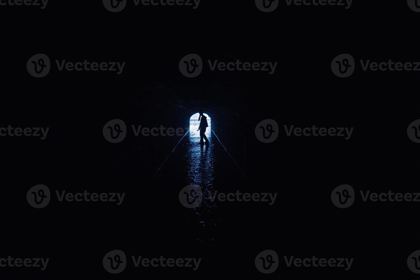 Silhouette of a woman in a tunnel photo