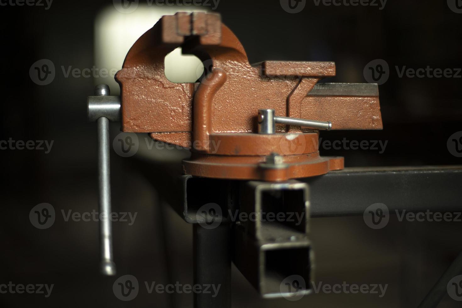 Fasteners in workshop. Holder for parts. Tool for squeezing workpiece. photo