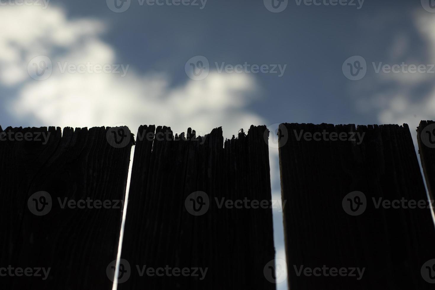 Close-up of board fence. Cracked fence board. Details of countryside. photo