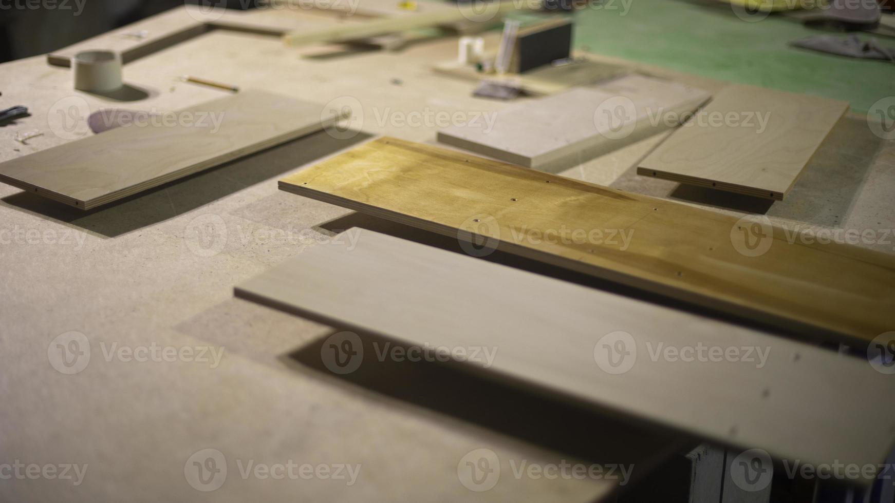Boards are on table. Materials for creating furniture. Details of carpentry workshop. photo