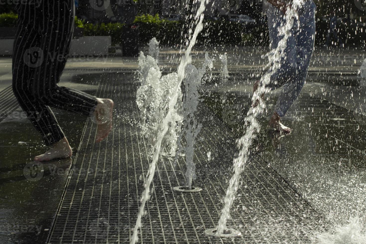 Fountain in city. City fountain on square. Spray of water. photo