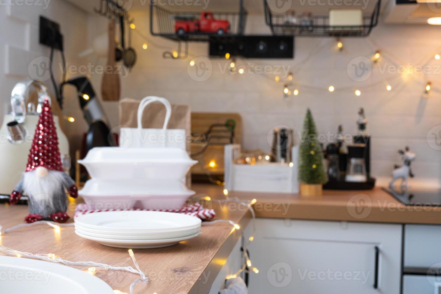 Food delivery service containers on table white scandi festive kitchen in christmas decor. Eve New year, saving time, too lazy to cook, hot order, disposable plastic box in fairy light. mock up photo