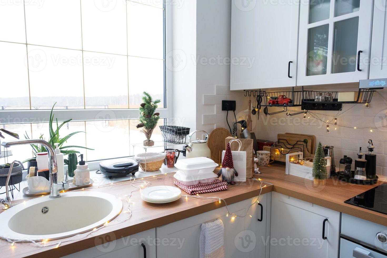 Food delivery service containers on table white scandi festive kitchen in christmas decor. Eve New year, saving time, too lazy to cook, hot order, disposable plastic box in fairy light. mock up photo