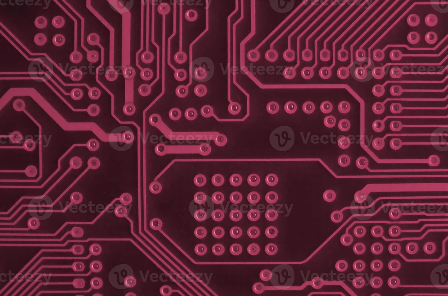 Close up of ed micro circuit board. Abstract technology background.  Image toned in Viva Magenta, color of the 2023 year photo