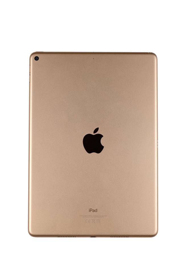 KHARKIV, UKRAINE - JANUARY 27, 2022 Brand new Apple iPad golden body surface with company logo on white background. Apple Inc. is an American technology company photo