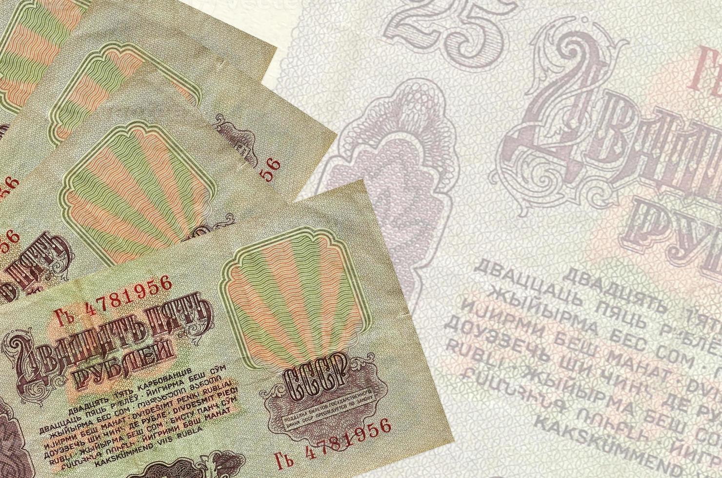 25 russian rubles bills lies in stack on background of big semi-transparent banknote. Abstract business background photo