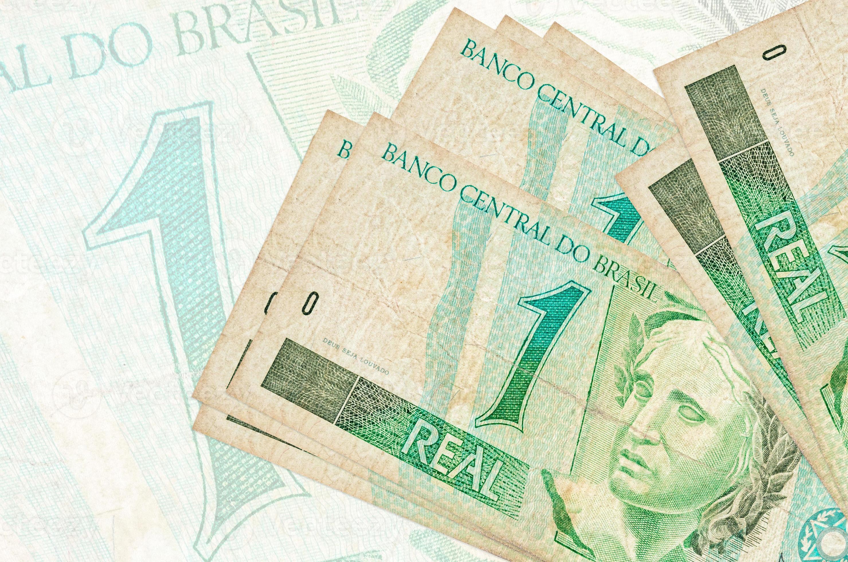 1-brazilian-real-bills-lies-in-stack-on-background-of-big-semi