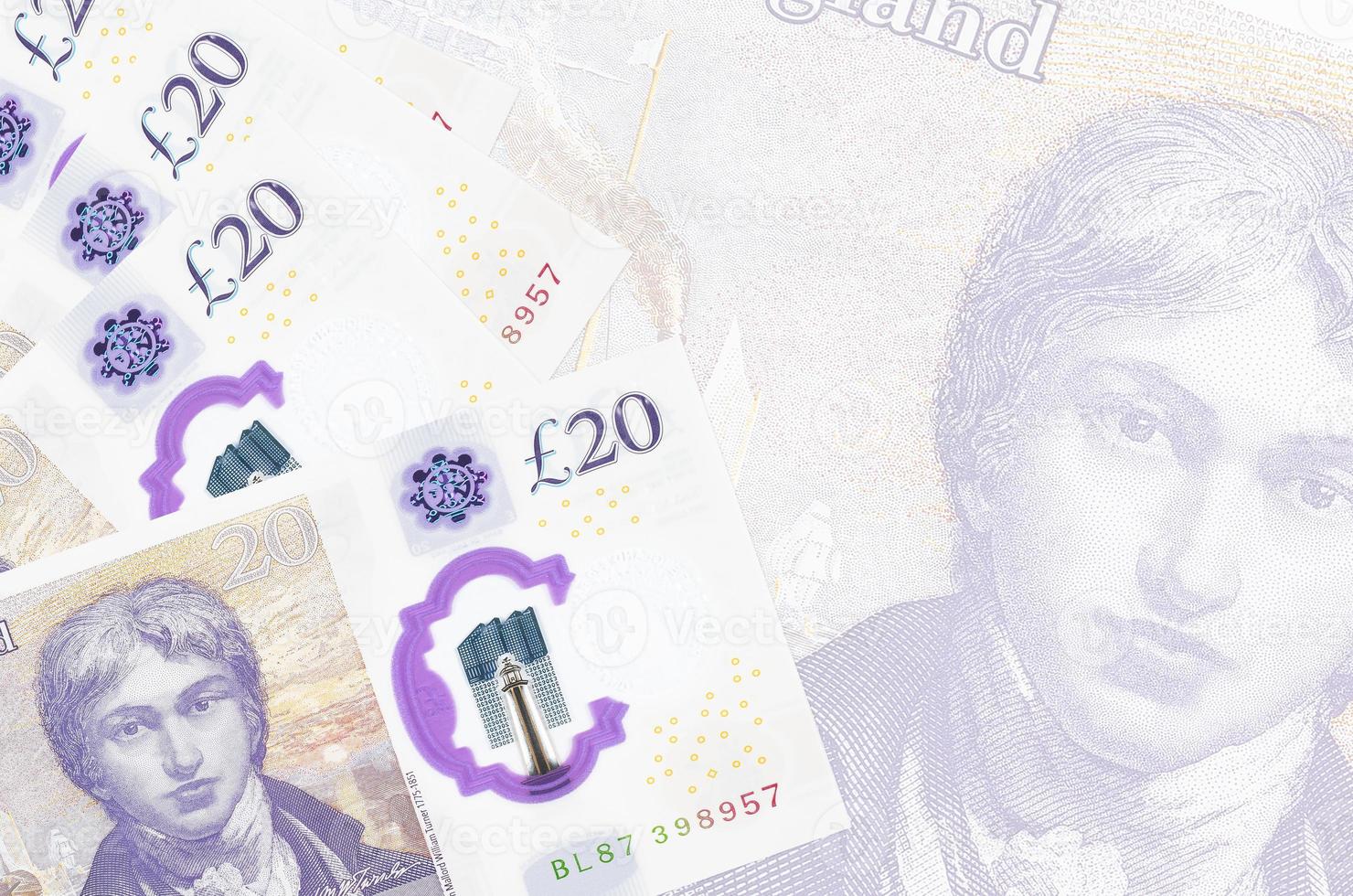 20 British pounds bills lies in stack on background of big semi-transparent banknote. Abstract business background photo
