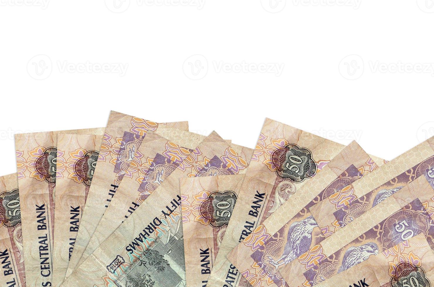 50 UAE dirhams bills lies on bottom side of screen isolated on white background with copy space. Background banner template photo