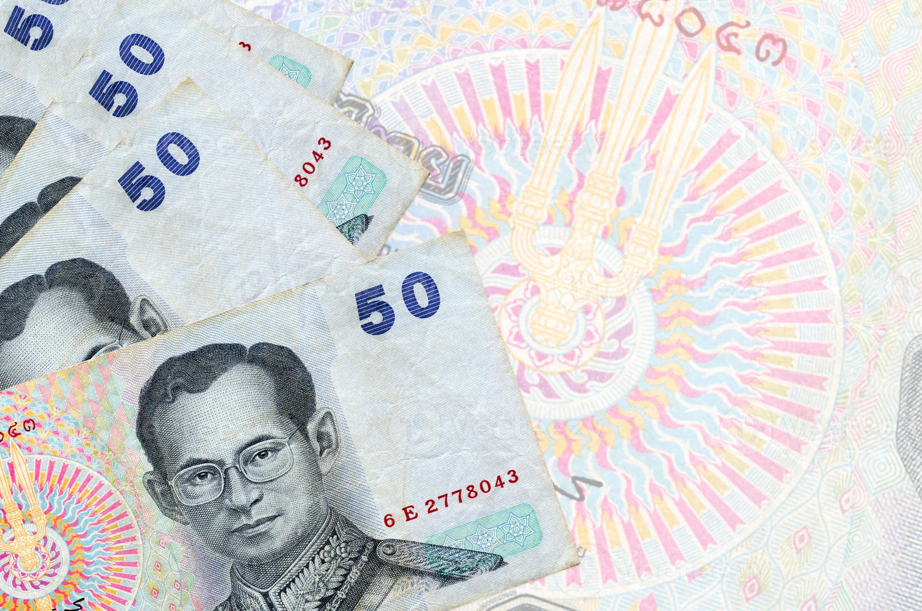 50 Thai Baht Bills Lies In Stack On Background Of Big Semi transparent 50-thai-baht-bills-lies-in-stack-on-background-of-big-semi-transparent