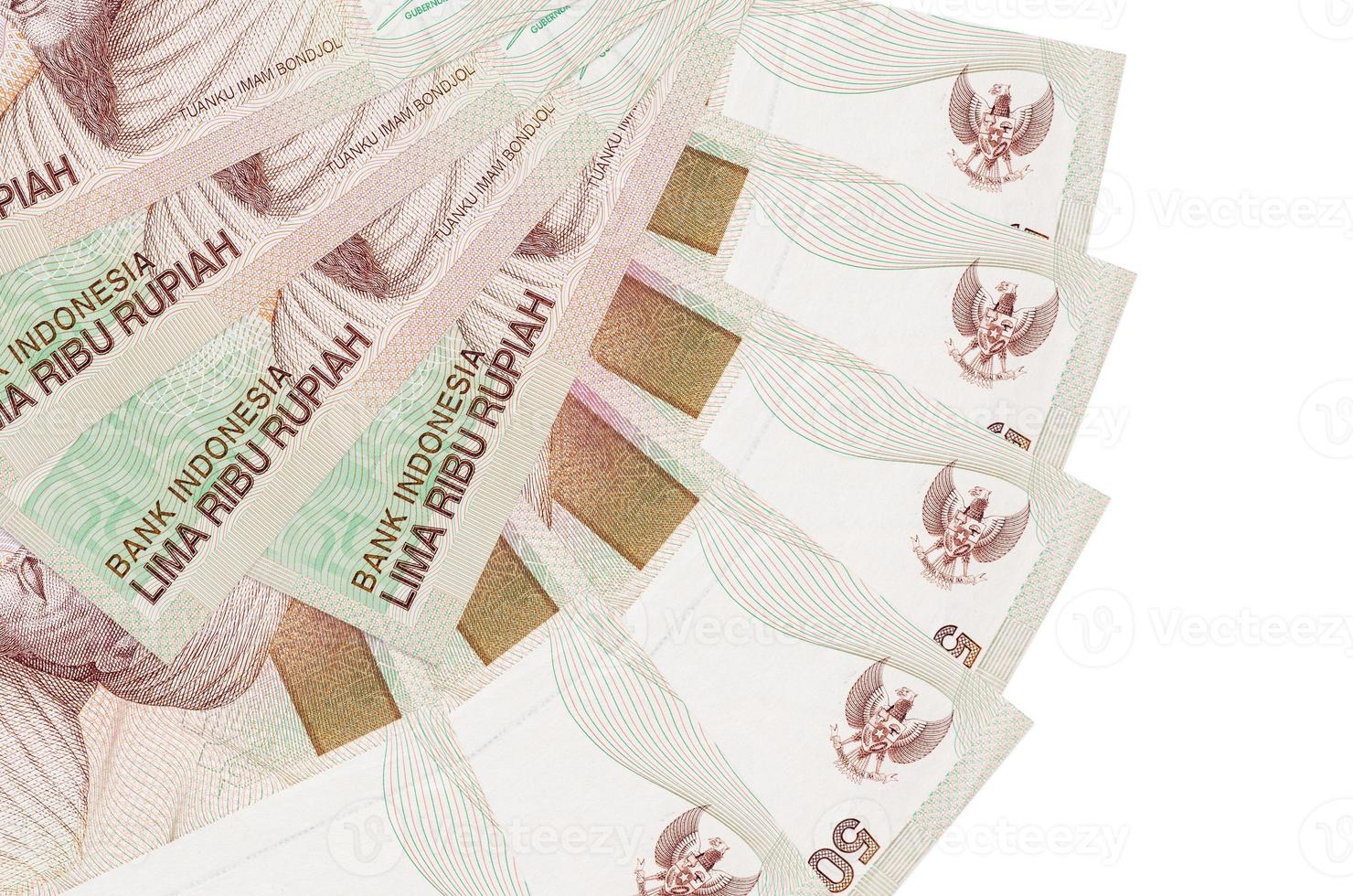 5000 Indonesian rupiah bills lies isolated on white background with copy space stacked in fan shape close up photo