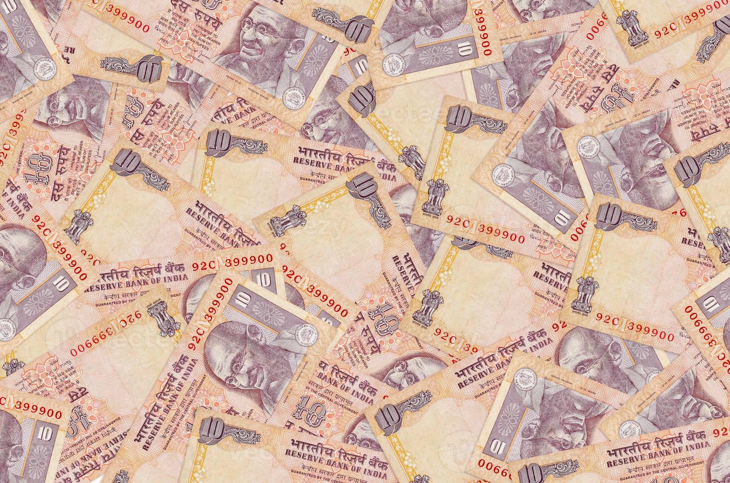 10 Indian rupees bills lies in big pile. Rich life conceptual background photo