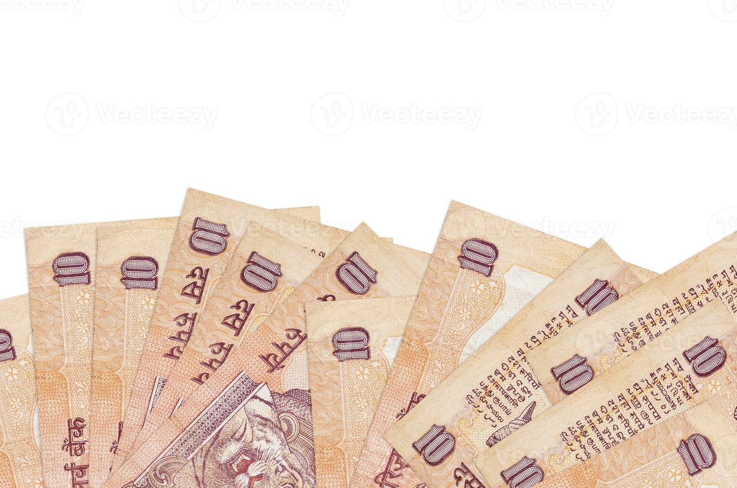 10 Indian rupees bills lies on bottom side of screen isolated on white background with copy space. Background banner template photo
