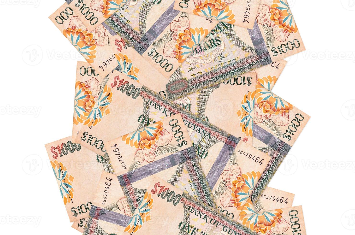 1000 Guyanese dollars bills flying down isolated on white. Many banknotes falling with white copyspace on left and right side photo