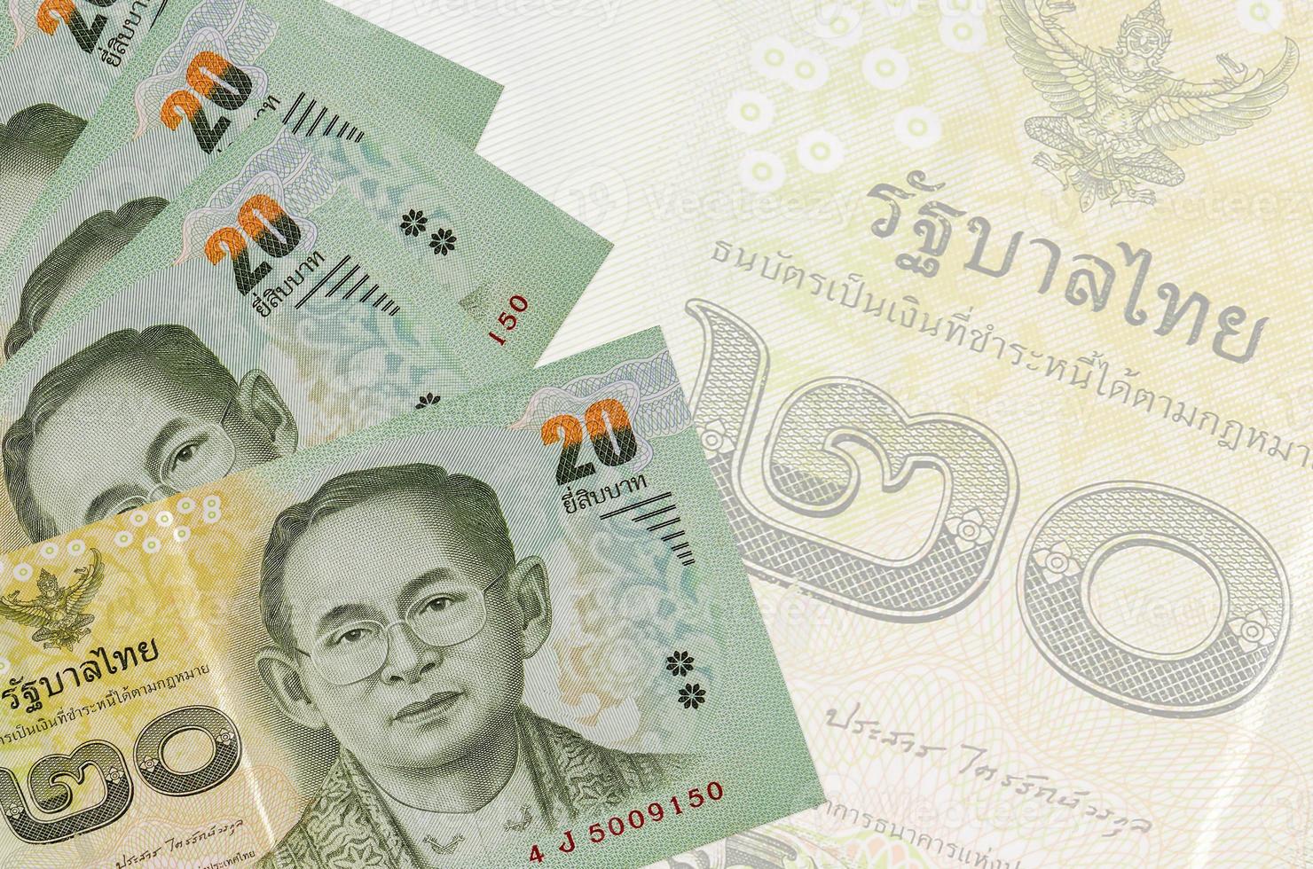 20 Thai Baht bills lies in stack on background of big semi-transparent banknote. Abstract business background photo