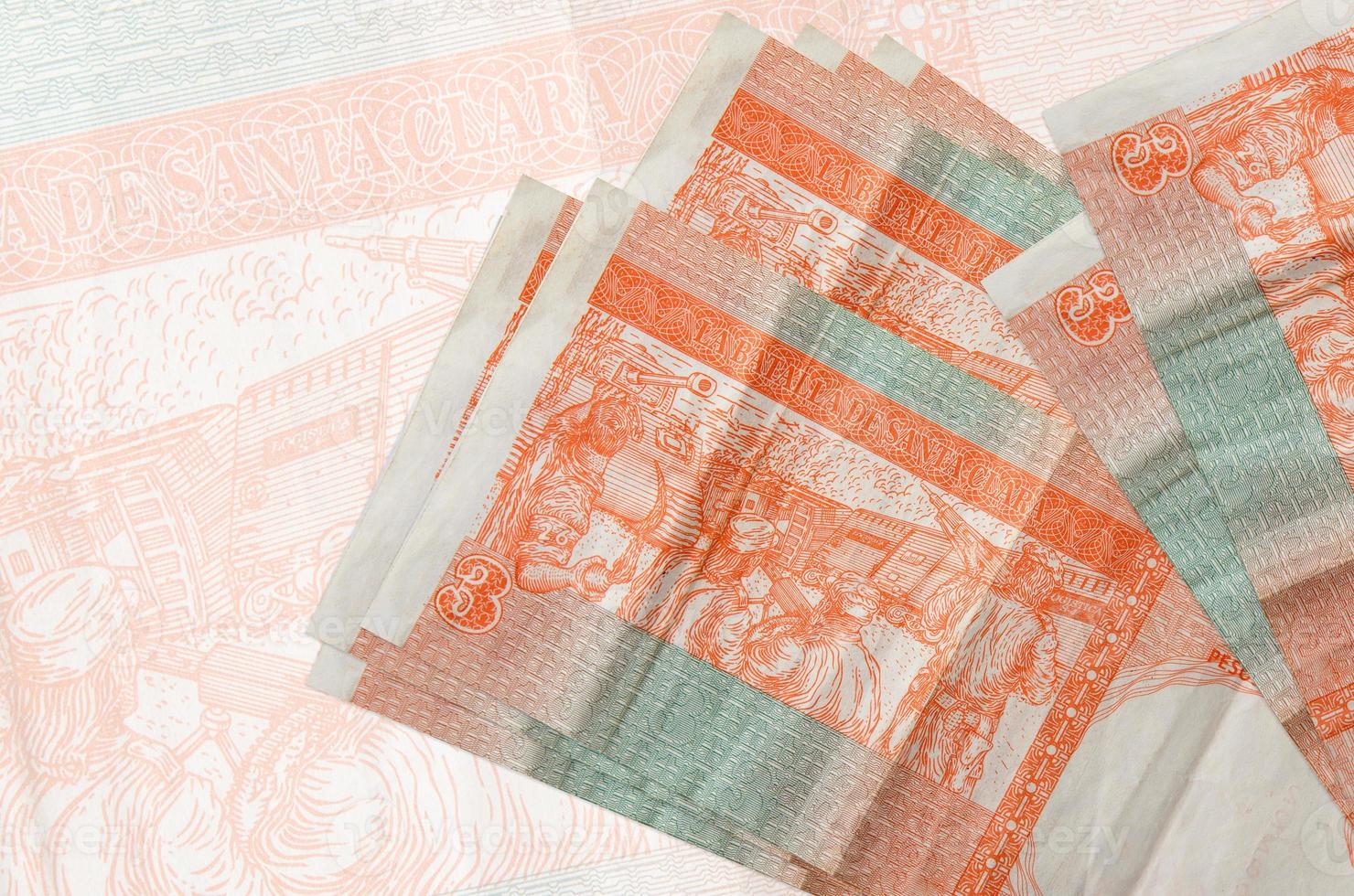 3 cuban pesos convertibles bills lies in stack on background of big semi-transparent banknote. Abstract presentation of national currency photo