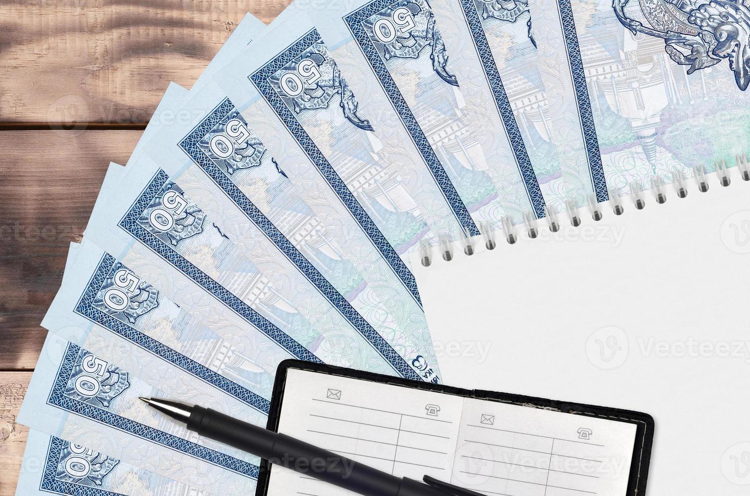 50 Sri Lankan rupees bills fan and notepad with contact book and black