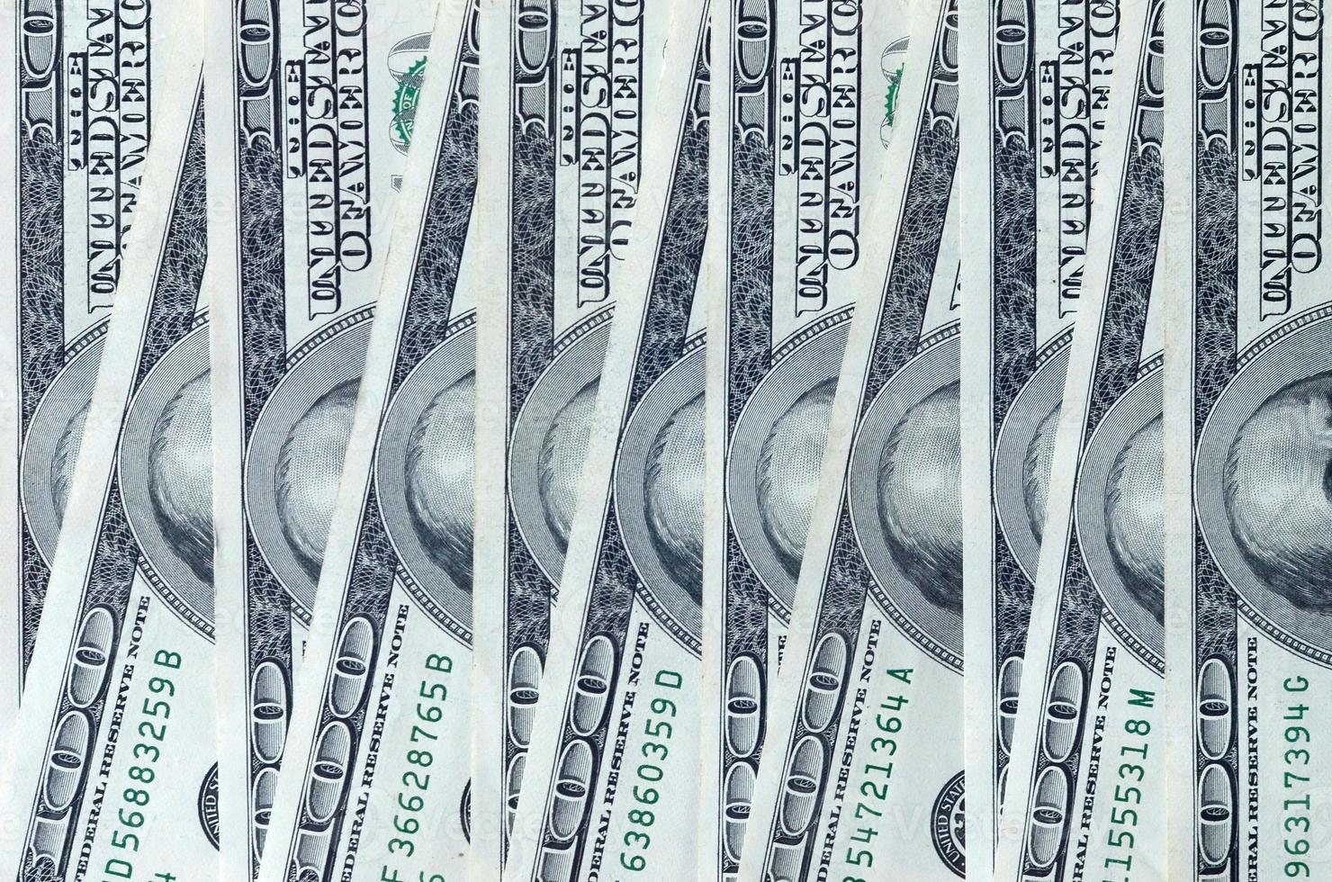 Abstract backdrop with many hundred dollar bills close up photo