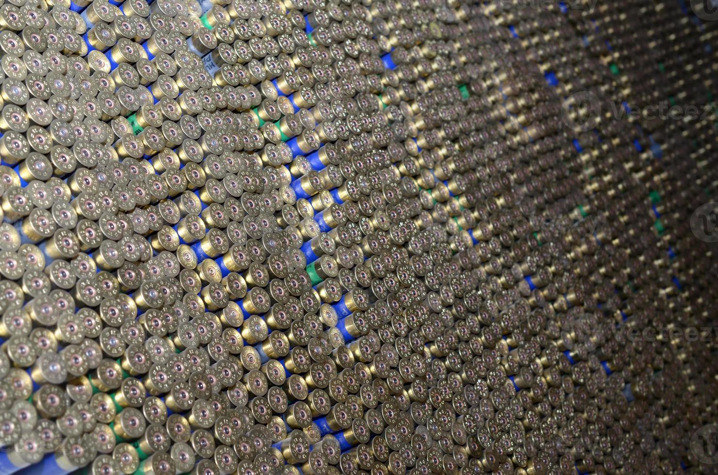 Pattern of 12 gauge cartridges for shotgun bullets. Shells for hunting rifle close up. Backdrop for shooting range or ammunition trade concepts photo