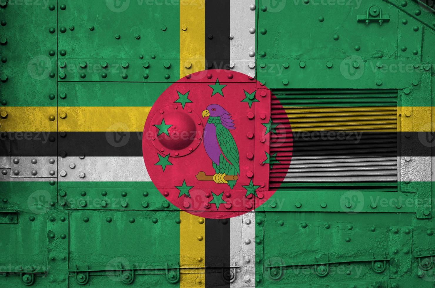 Dominica flag depicted on side part of military armored tank closeup. Army forces conceptual background photo