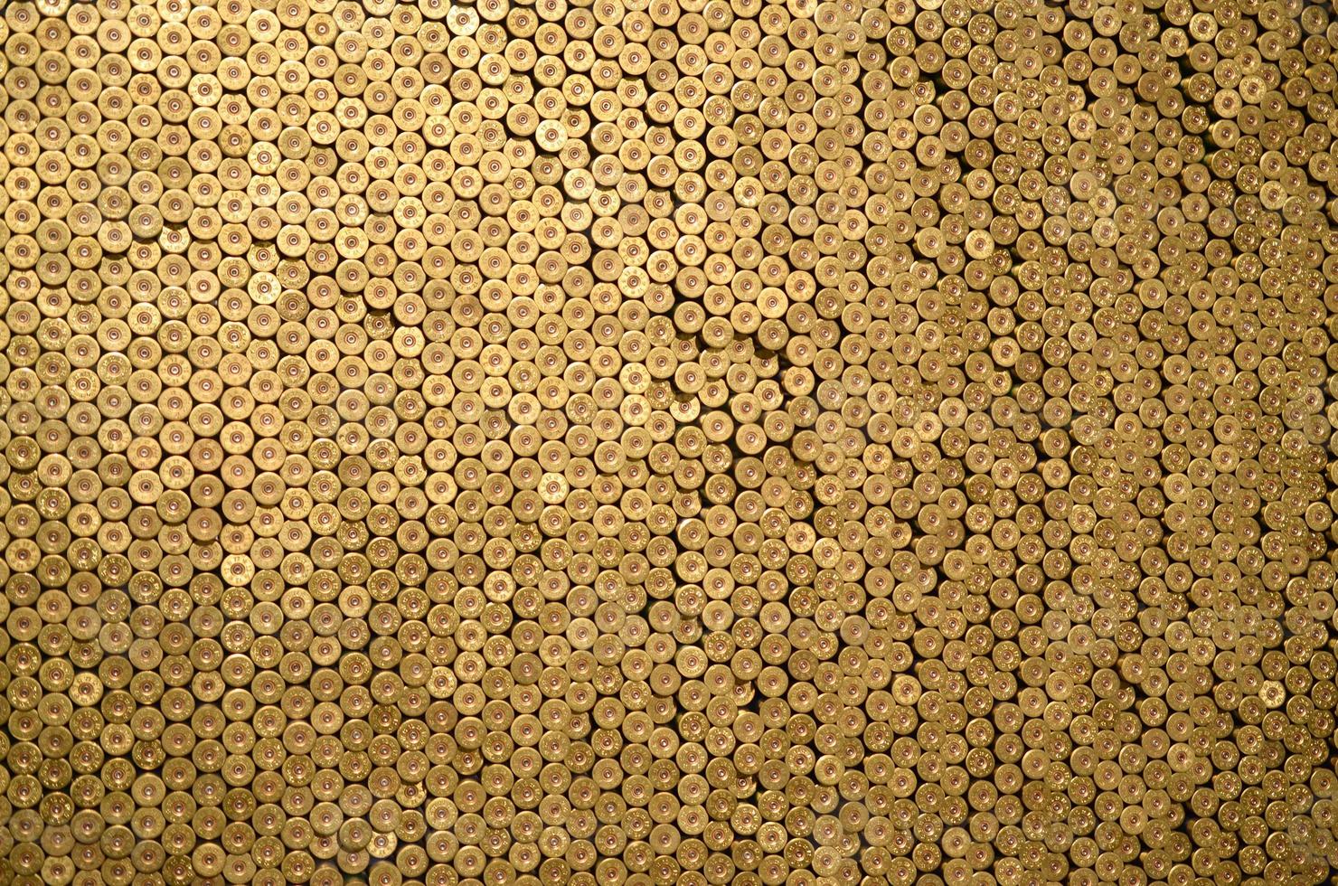 Pattern of 12 gauge cartridges for shotgun bullets. Shells for hunting rifle close up. Backdrop for shooting range or ammunition trade concepts photo