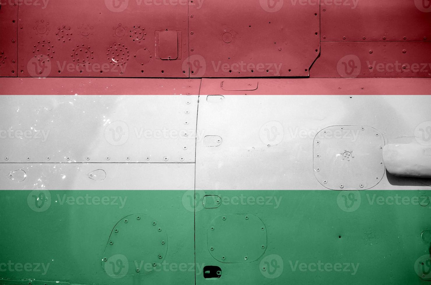 Hungary flag depicted on side part of military armored helicopter closeup. Army forces aircraft conceptual background photo
