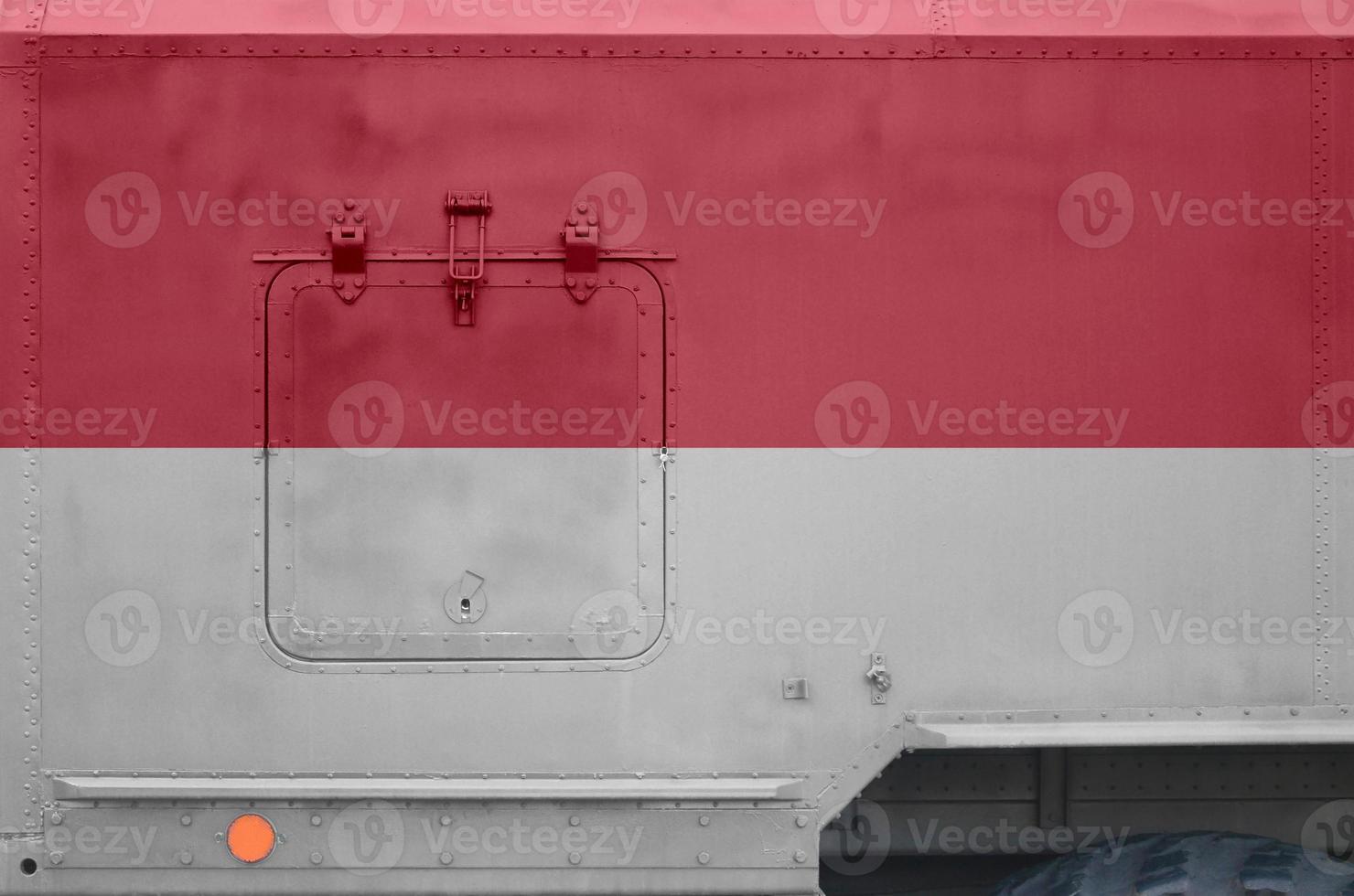 Indonesia flag depicted on side part of military armored truck closeup. Army forces conceptual background photo