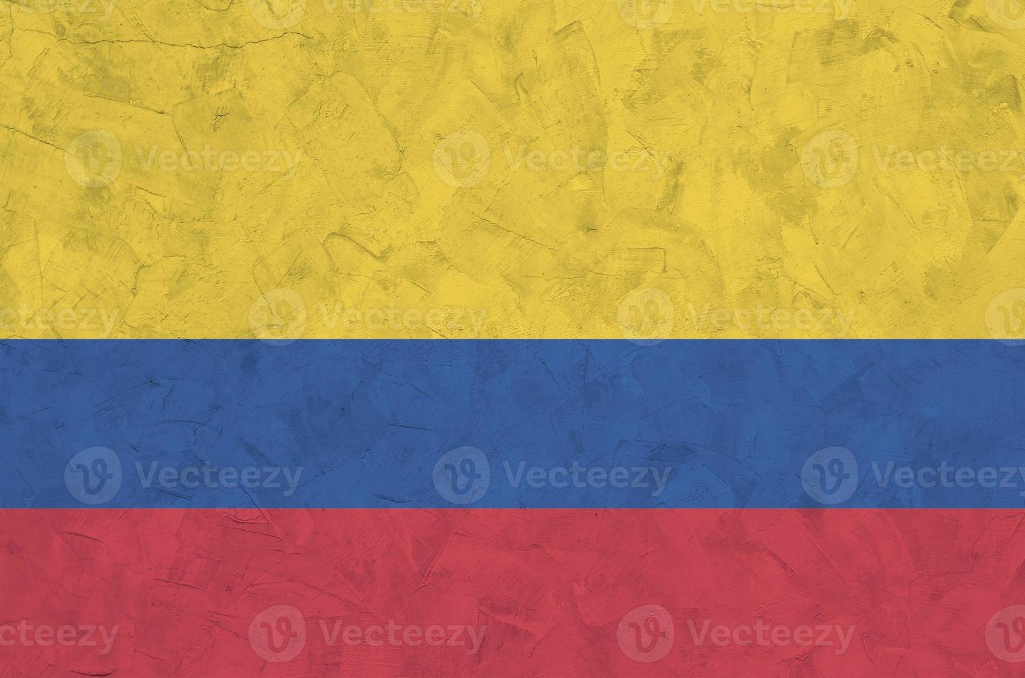 Colombia flag depicted in bright paint colors on old relief plastering wall. Textured banner on rough background photo