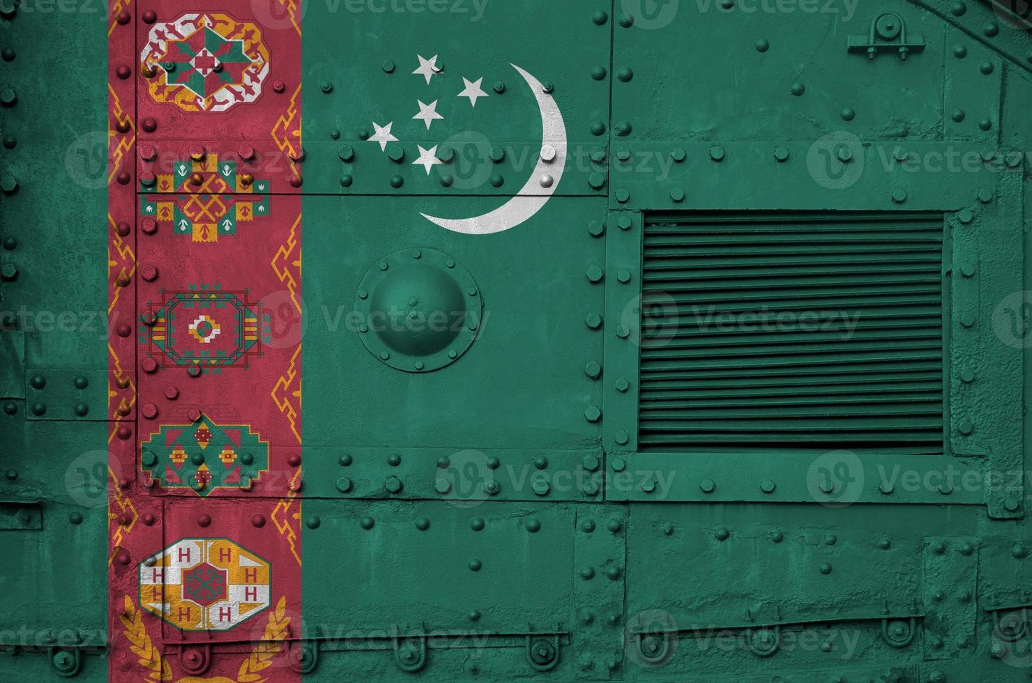 Turkmenistan flag depicted on side part of military armored tank closeup. Army forces conceptual background photo