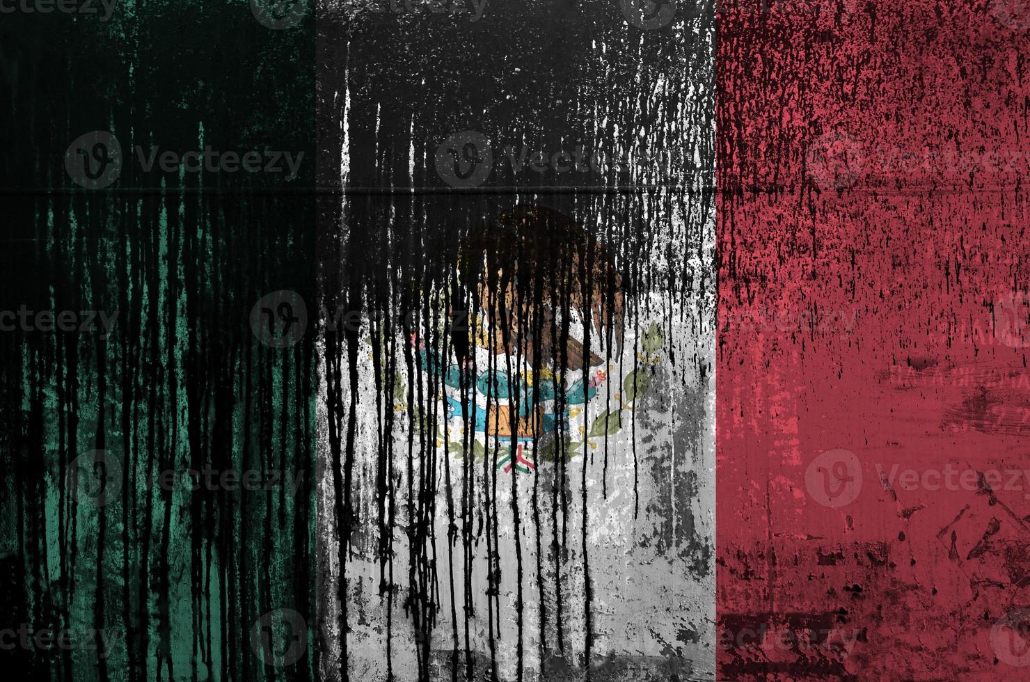 Mexico flag depicted in paint colors on old and dirty oil barrel wall closeup. Textured banner on rough background photo