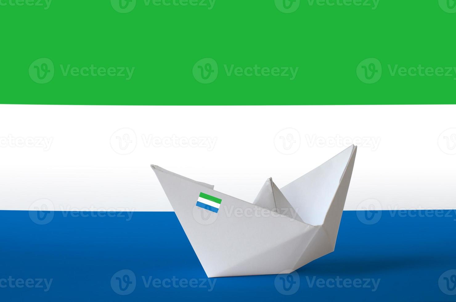 bandera de sierra leona representada en el primer plano del barco de origami de papel. concepto de artes hechas a mano foto