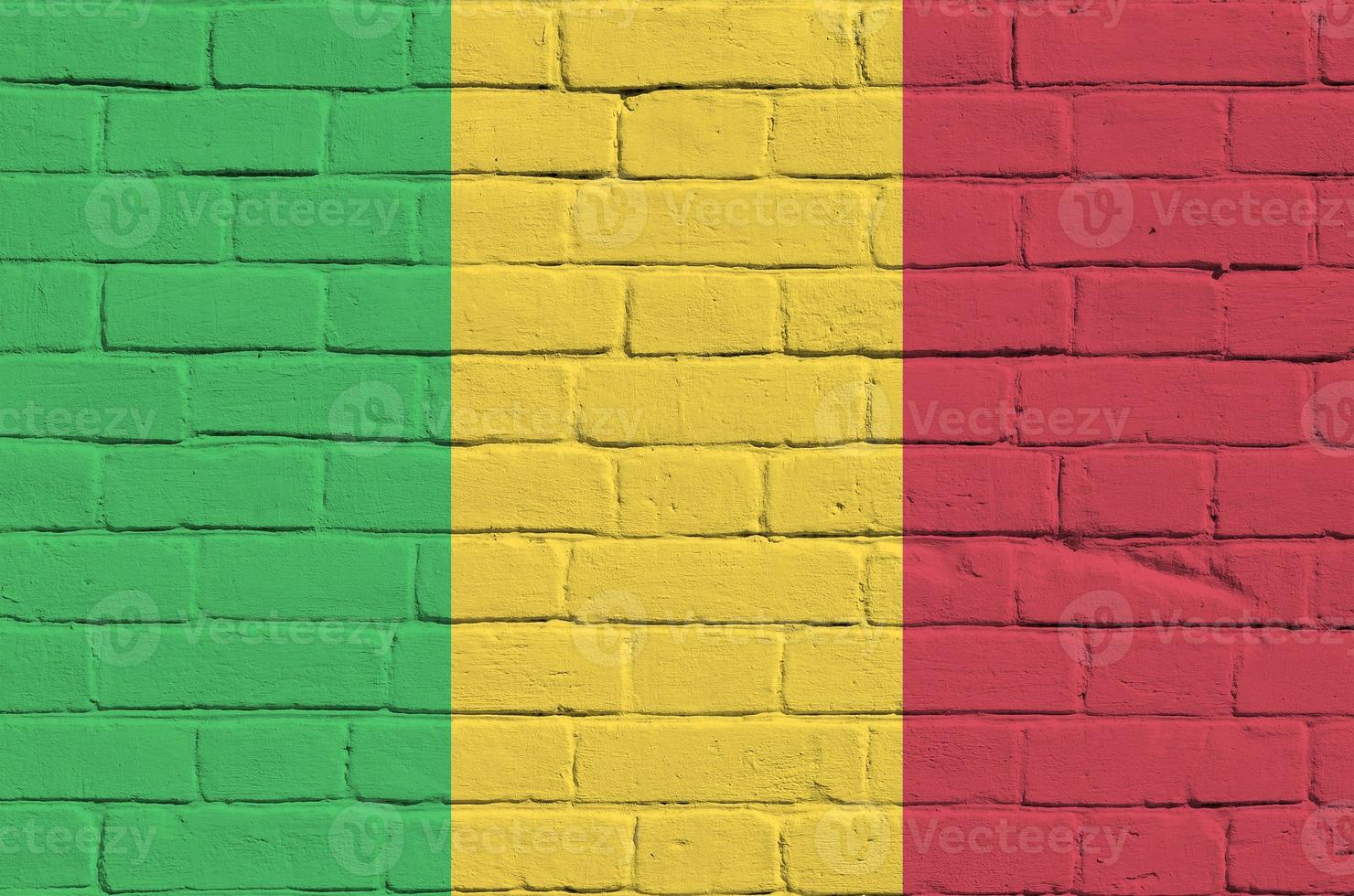 Mali flag depicted in paint colors on old brick wall. Textured banner on big brick wall masonry background photo