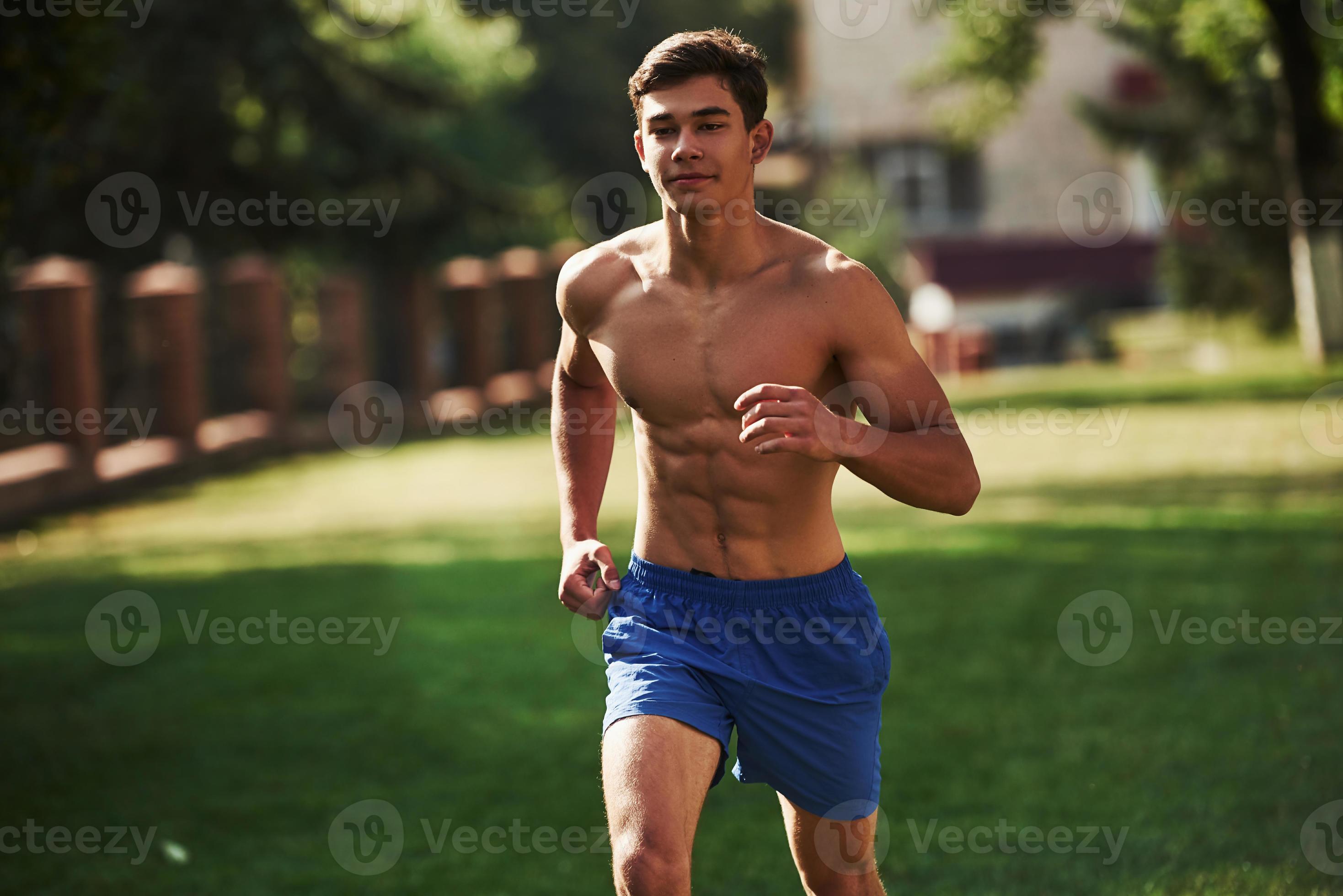 Going forward. Muscular shirtless man have fitness day and running in