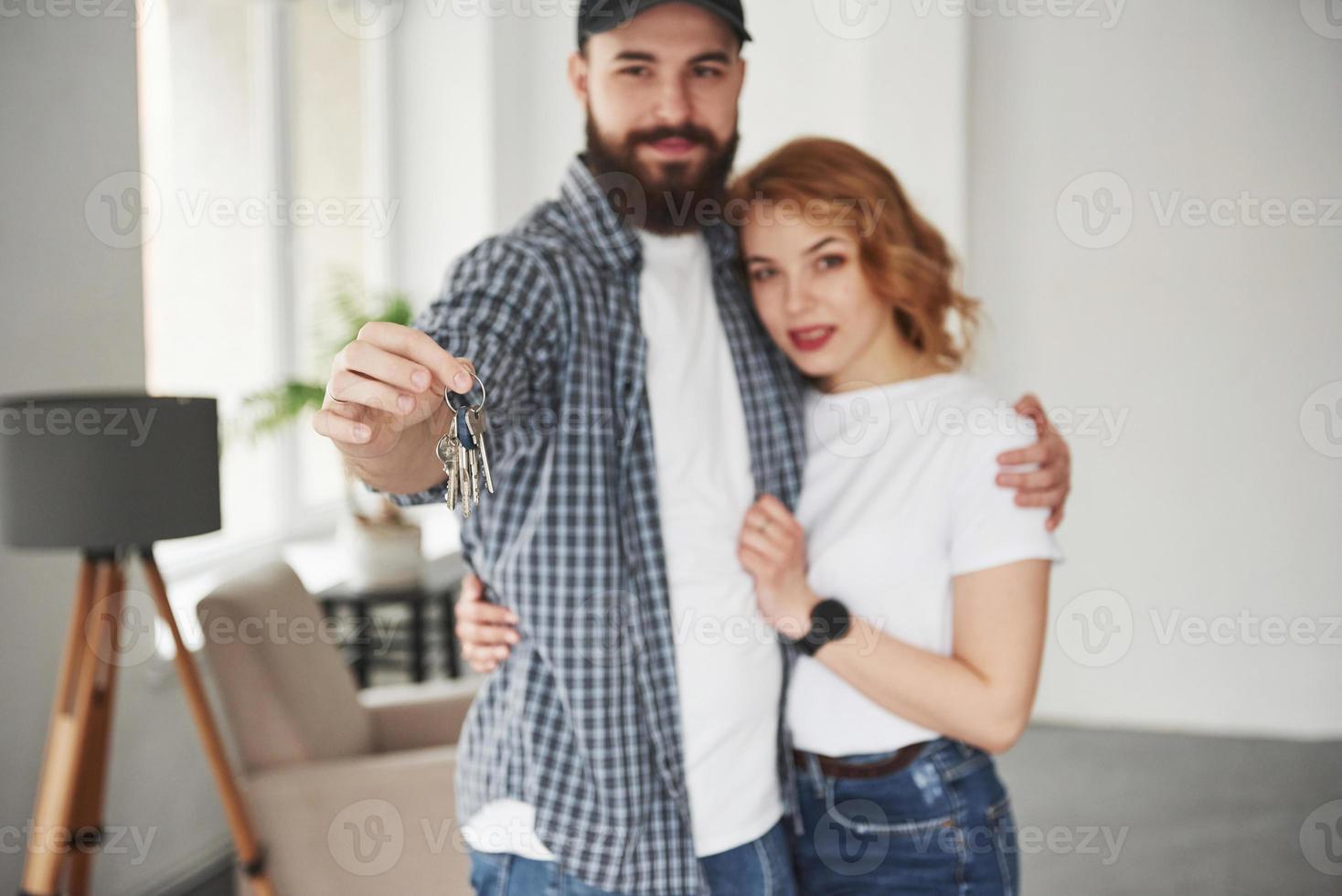 This is success. Happy couple together in their new house. Conception of moving photo