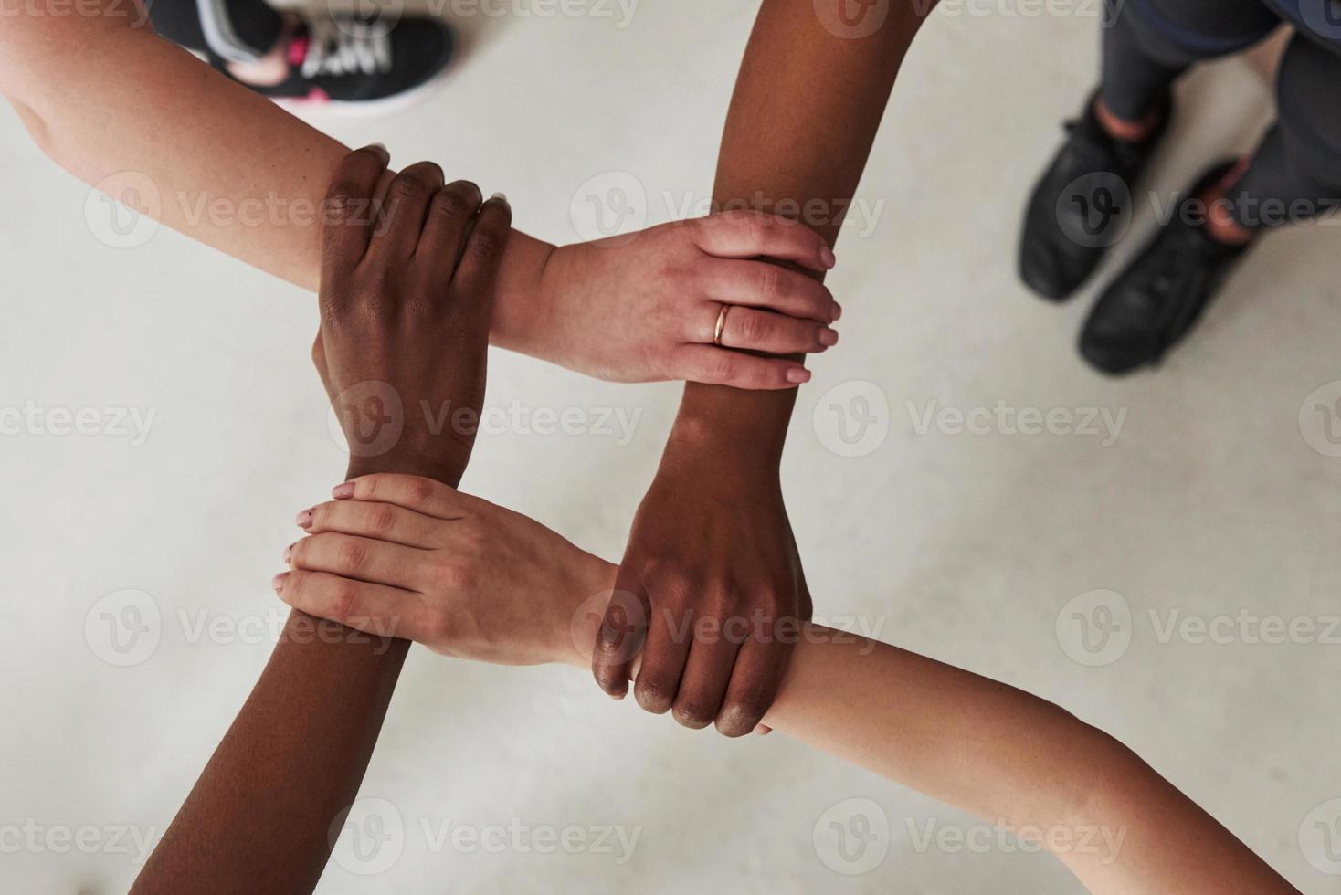 Top view of women's hands holds each other. Conception of success photo