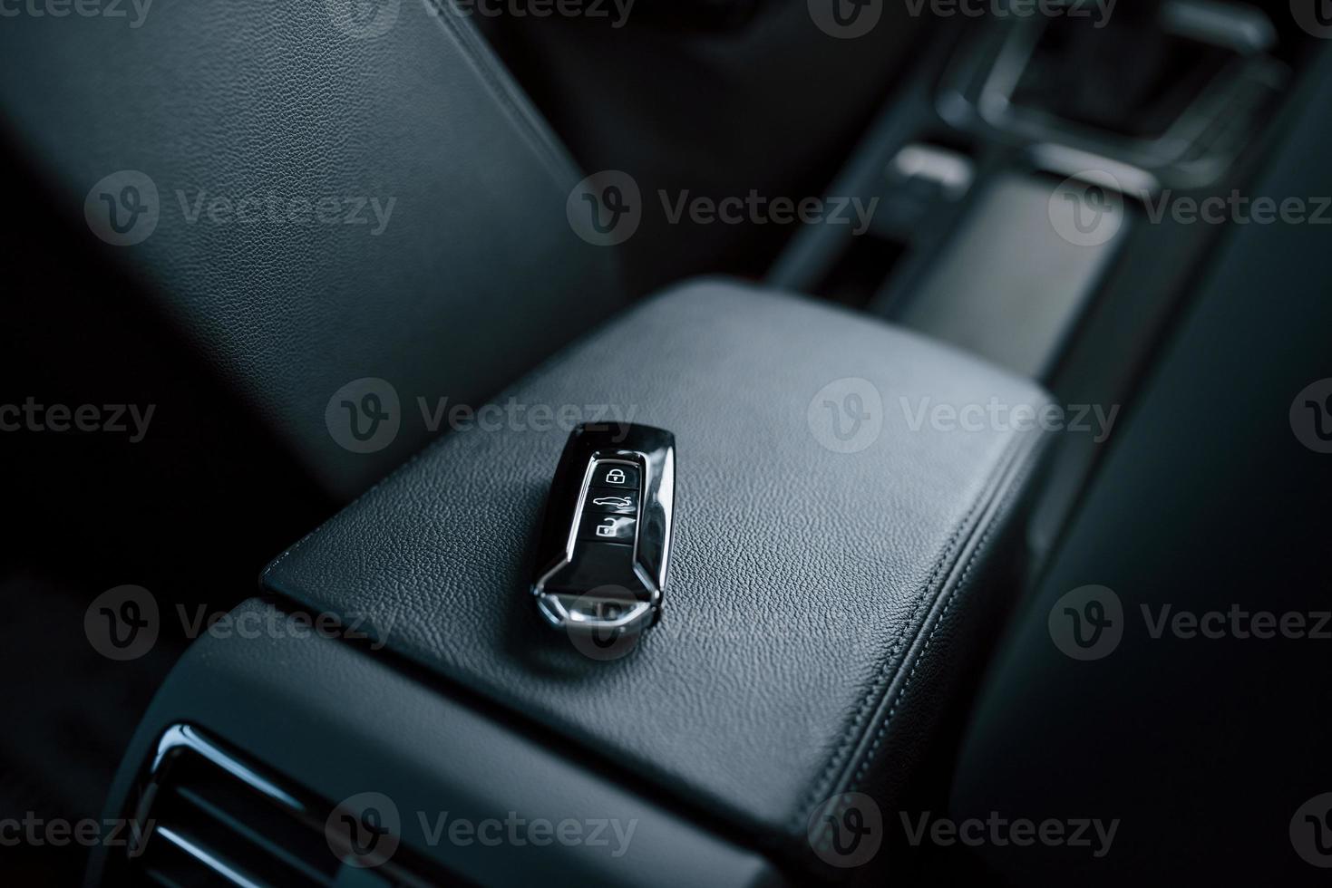 Close up photo of keys lying donw inside brand new modern car