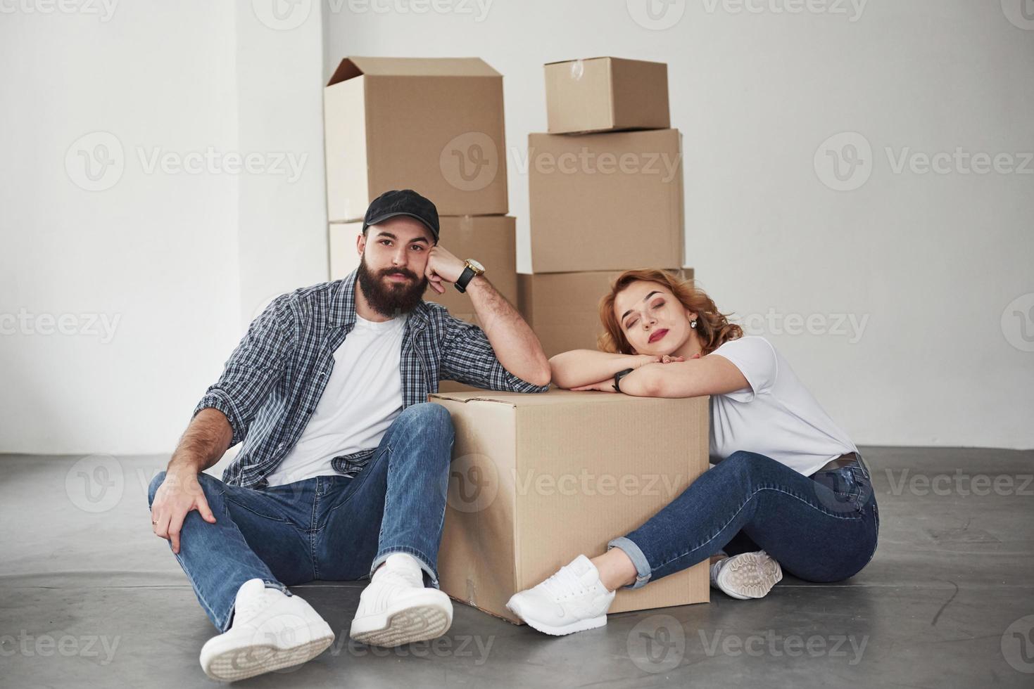 Tired after long road. Happy couple together in their new house. Conception of moving photo