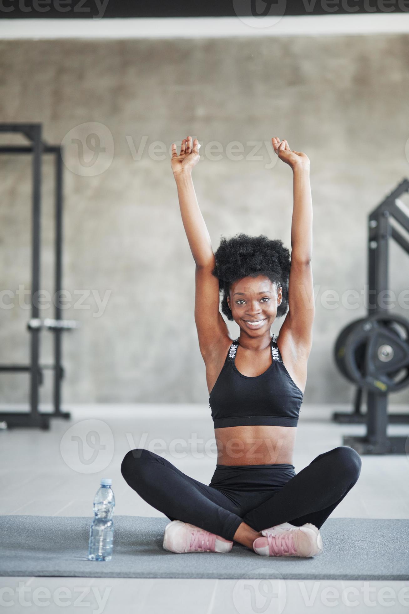 With hands up. African american woman with curly hair and in