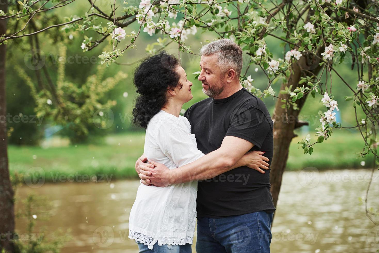 Looking at each other with love. Cheerful couple enjoying nice weekend outdoors. Good spring weather photo