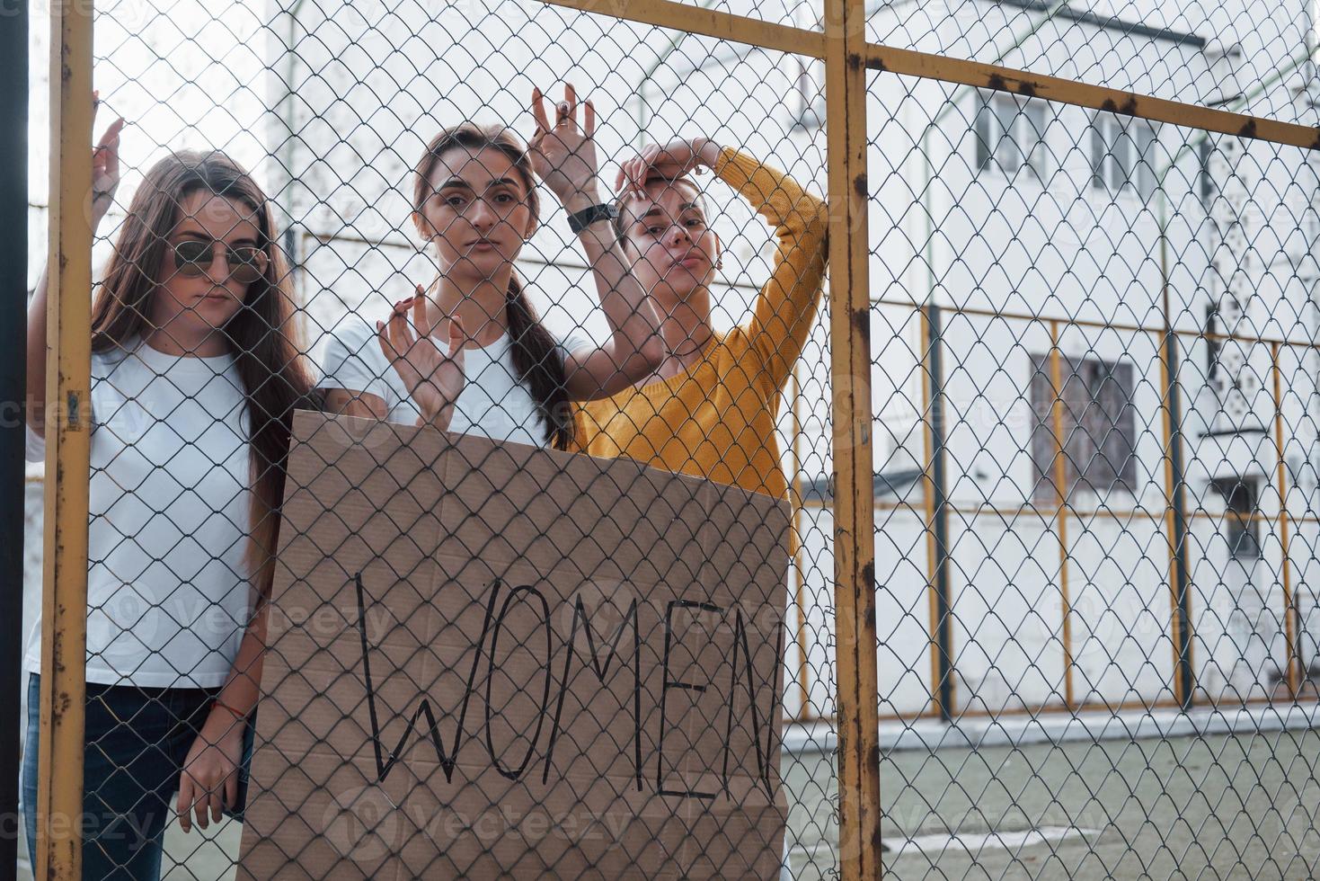 Near big white building. Group of feminist women have protest for their rights outdoors photo