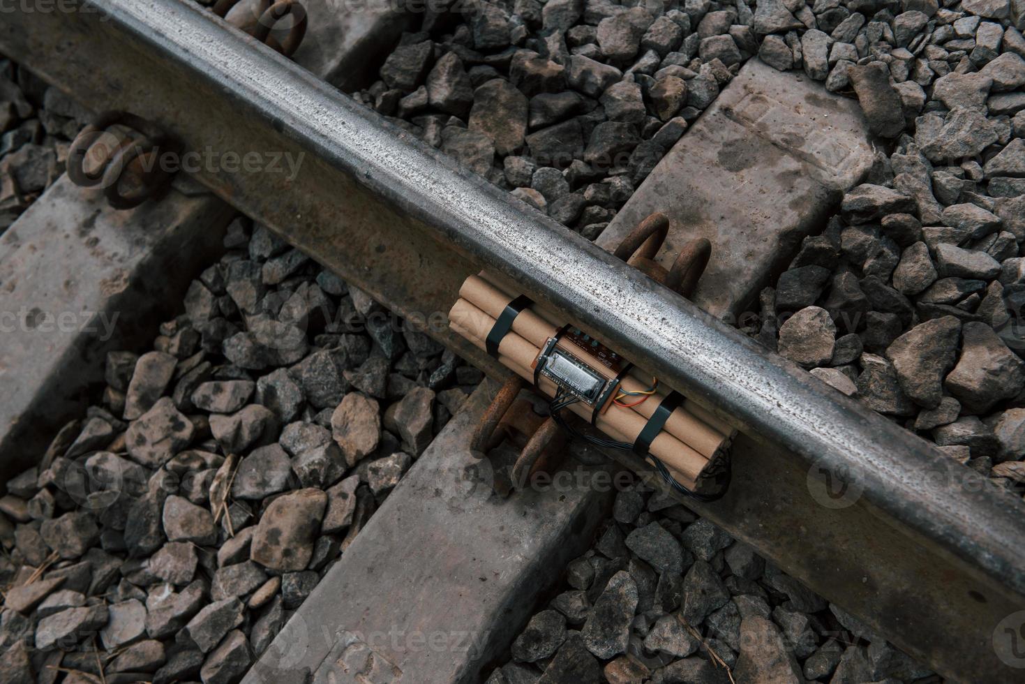 Top view. Timebomb on the railway at daytime outdoors. Conception of terrorism and danger photo