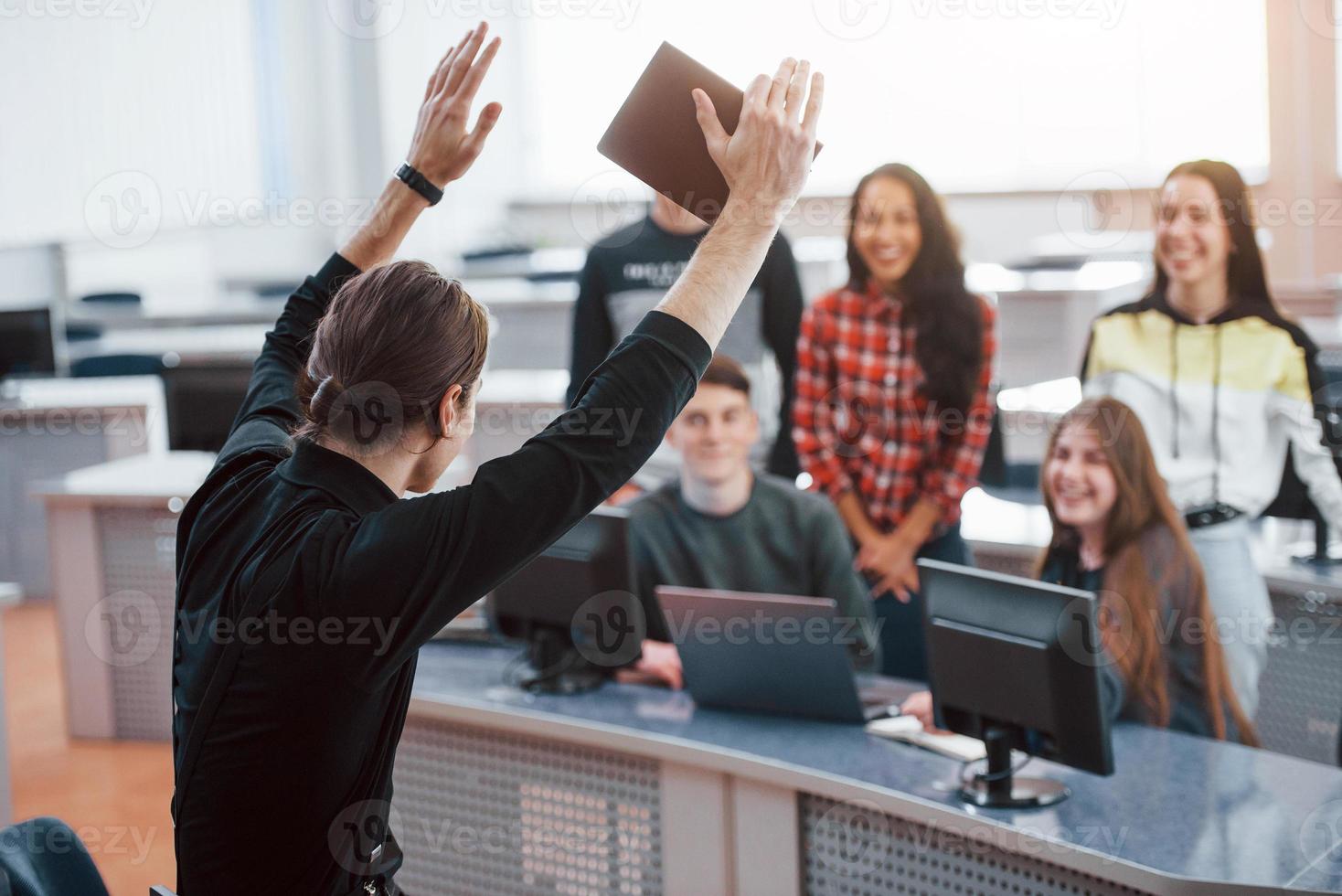 It's will be success. Group of young people in casual clothes working in the modern office photo