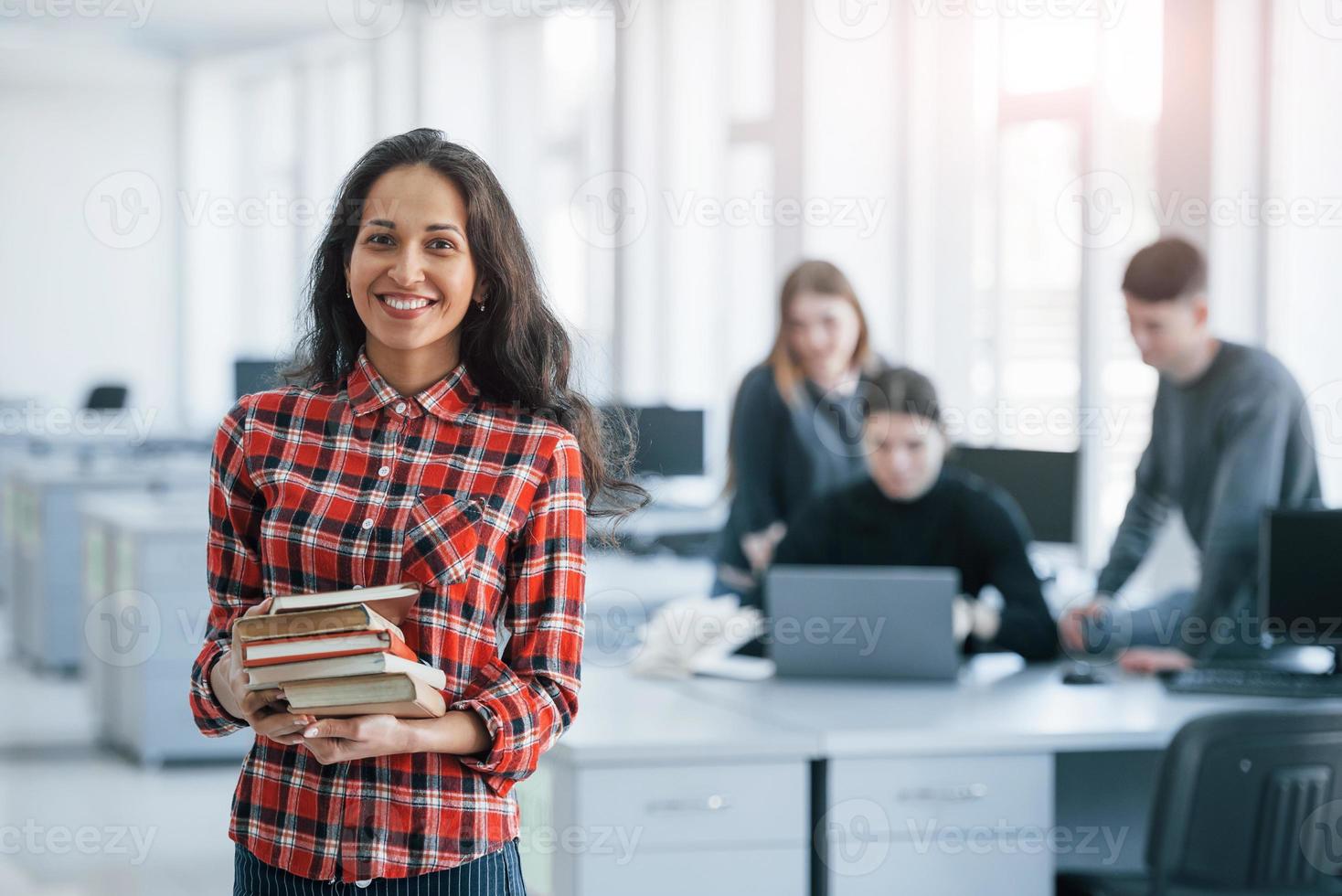 Natural lighting. Group of young people in casual clothes working in the modern office photo