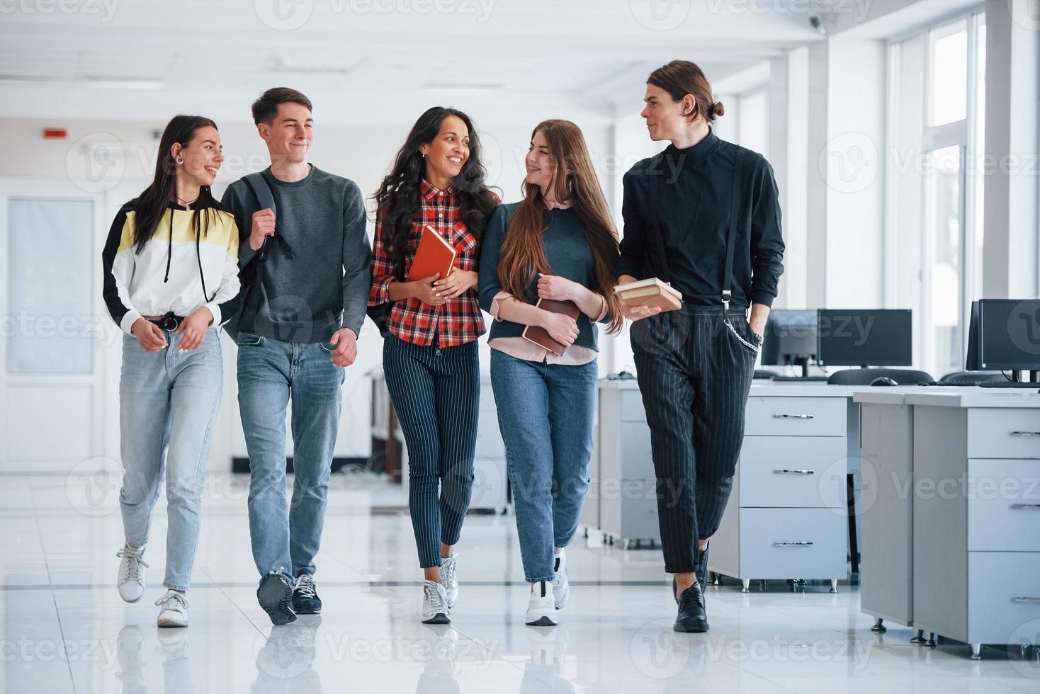 Work will not wait. Group of young people walking in the office at their break time photo