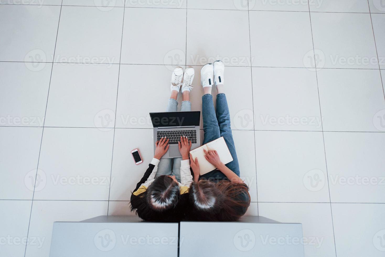 Searching for the specific information. Top view of young people in casual clothes working in the modern office photo