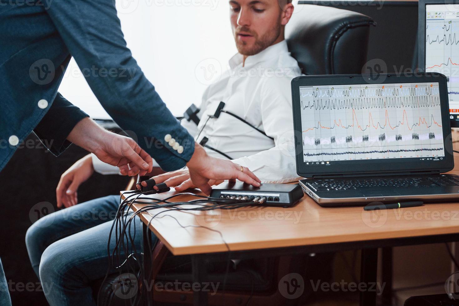 Few minutes and we will done. Preparation for the polygraph test. Conception of the lie detector photo