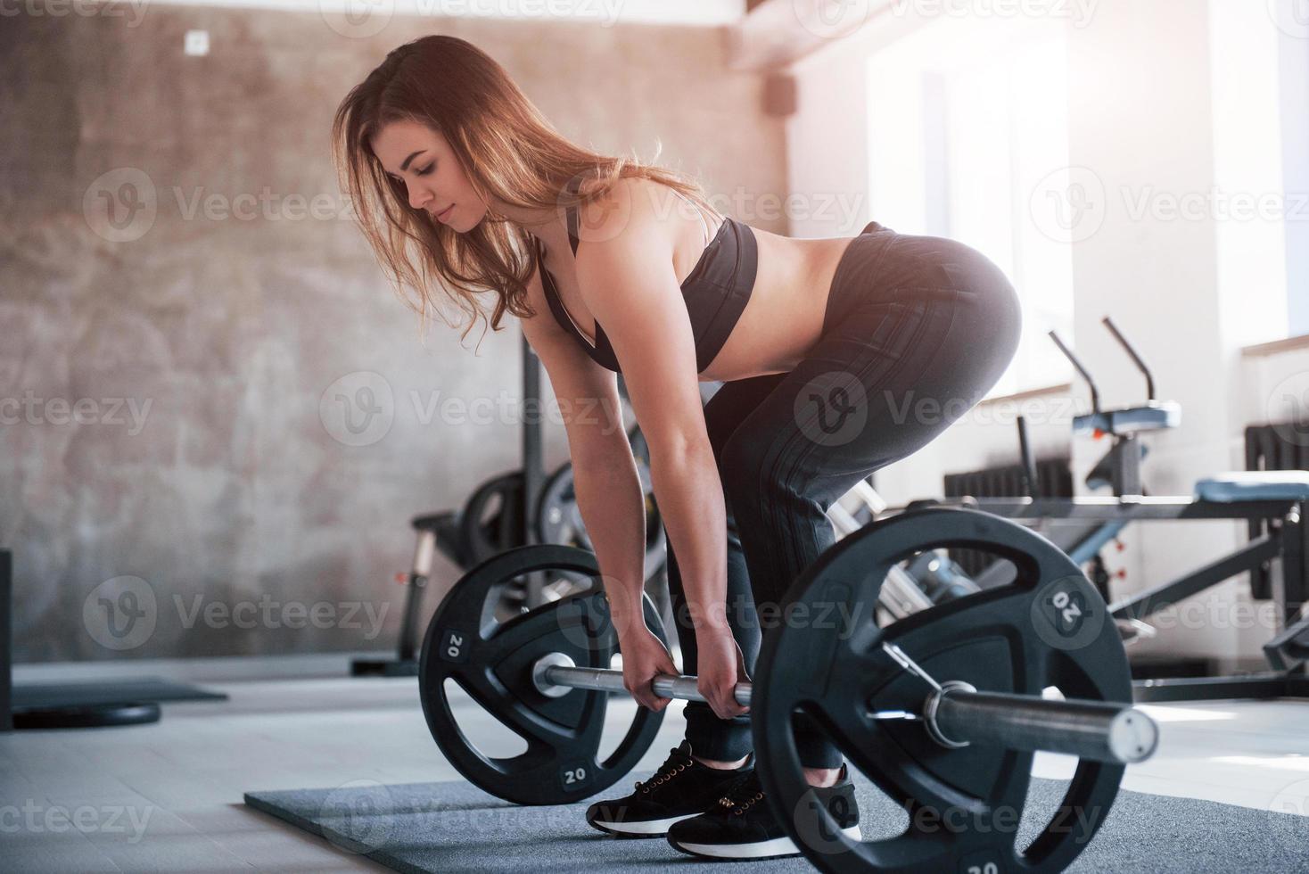 Strong girl. Photo of gorgeous blonde woman in the gym at her weekend time