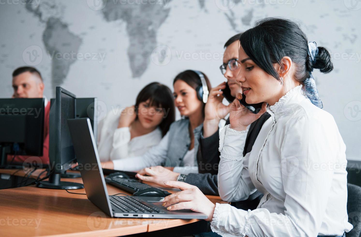 Give me a minute, I will find solution. Young people working in the call center. New deals is coming photo