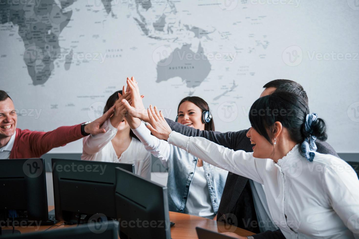 Job well done. Young people working in the call center. New deals is coming photo